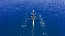 Aerial Drone Photo Of Sport Canoe Operated By Team Of Young Trained Athletes In Deep Blue Aegean Sea