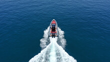 Aerial Drone Photo Of Inflatable Rigid Power Boat Cruising In High Speed In Aegean Deep Blue Sea Bay, Greece