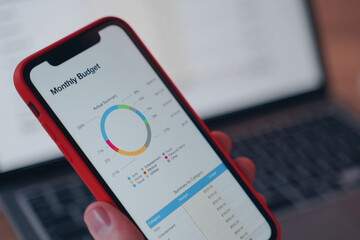 man is holding phone in hand. wireless trading concept. round financial diagram on smartphone.