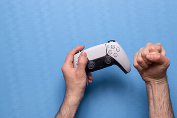 Wall Mural - Hand hold new joystick. Gamer play game with gamepad controller. Gaming man holding simulator joypad. Person with keypad joystic in arms.