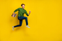 Full Length Photo Of Excited Pretty Guy Dressed Sweater Walking Modern Device Empty Space Isolated Yellow Color Background