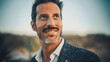 © Gorodenkoff - Close Up Portrait of a Happy Adult Male with Moustache and Beard Posing for Camera. Handsome Middle Aged Multiethnic Caucasian Male in a Suit Charmingly Smiling. Warm Color Edit.