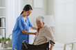 Young Asian woman, nurse, caregiver, carer help and assist a senior Asian woman on bed at home