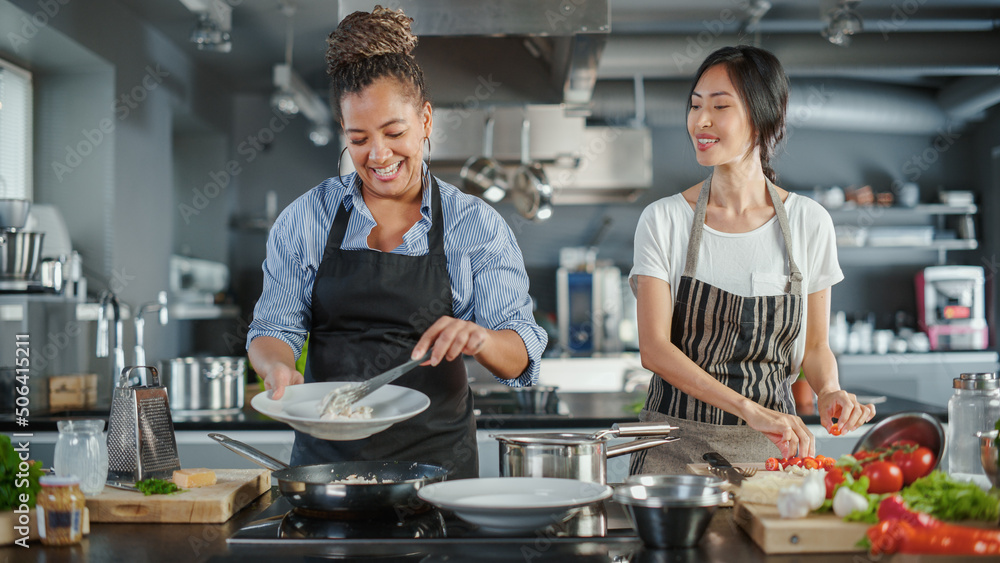 TV Cooking Show Kitchen with Two Master Chefs. Asian and Black Female ...