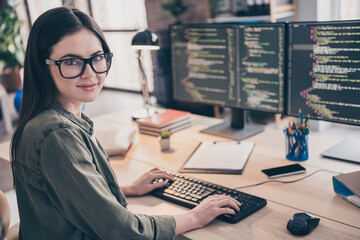 Profile side view portrait of attractive skilled cheery girl tech support writing html code css php at workplace workstation indoors