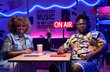 © AnnaStills - Young African American man and woman wearing fashionable outfits sitting at desk looking at camera after working together on podcast