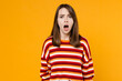 Young sad shocked angry surprised caucasian woman 20s in red striped sweatshirt look camera with opened mouth scream shout isolated on plain yellow background studio portrait People lifestyle concept