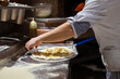 © arthurhidden - Pizza making process. Male chef hands making authentic pizza in the pizzeria kitchen.