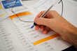 © Austockphoto - person filling out voting ballot paper forms for election