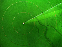Aerial View From A Drone Flying Above Green Farm Field Growing Crops Irrigation Pivot Sprinklers