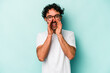 © Asier - Young caucasian man isolated on white background saying a gossip, pointing to side reporting something.