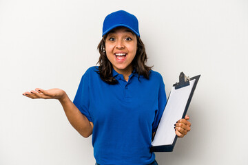 Wall Mural - Young hispanic woman delivery man isolated on white background receiving a pleasant surprise, excited and raising hands.