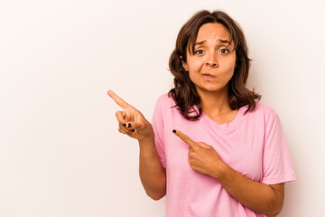 Wall Mural - Young hispanic woman isolated on white background shocked pointing with index fingers to a copy space.