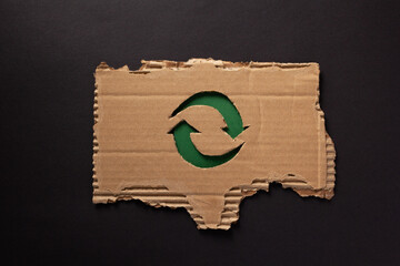 Wall Mural - Recycle symbol on  recycled paper background texture. Recycling idea concept and cardboard paper