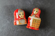 A red matryoshka doll on a black background. Traditional Russian toy.