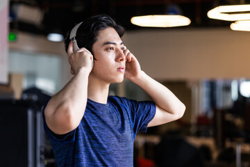 Young man in sportswear exercising at the gym