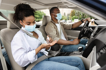 Wall Mural - African American Family Riding Car And Disinfecting Hands With Sanitizer