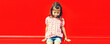 Summer portrait of little girl child wearing checkered shirt on red background in the city, blank copy space for advertising text