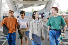 Diverse Group Of Teenagers In Skatepark Outdoors At Urban Area Wearing Sporty Outfits, Copy Space