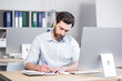 © Liubomir - Confident business man stocks broker sitting in front of monitor screen in office analyzing stat of index charts data analyses market trend. Forex trading agency worker agent reviewing profits growth