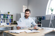 © Liubomir - Thinking businessman working with documents in the office, man reviewing financial reports