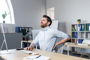 Businessman at work, tired has severe back pain