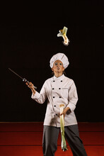 Skilled Clown Chef Slicing Veggie In Air On Stage