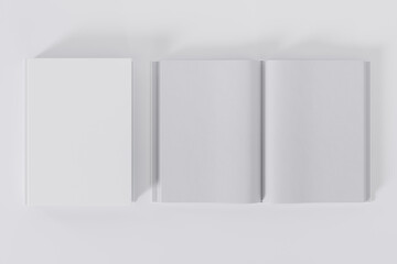 Wall Mural - Mockup of two rectangular books with blank, white glossy covers on white background. Both closed and open. Isolated with clipping path.