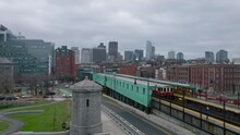 Forwards Fly Along Train Stop In City. Subway Units Driving On Overground Track On Cloudy Day. Boston, USA