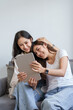 © Jirapong - lgbtq, lgbt concept, homosexuality, portrait of two asian women enjoying together and showing love for each other while using tablet