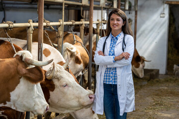 Wall Mural - Woman veterinarian standing in stable