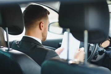 Attractive elegant happy man in good car