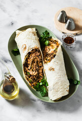 Wall Mural - burrito with fried salmon and vegetables on a marble table. Mexican cuisine