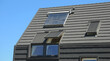 Modern house rooftop with attic panoramic windows. Attic skylight windows.