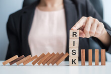 Businesswoman Hand Stopping Falling Wooden Blocks Or Dominoes. Business, Risk Management, Solution, Insurance And Strategy Concepts