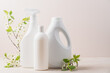 Set of white bottles with cleaning products and blossoming tree branches on beige background. Cleaning service concept.