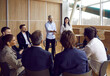© Studio Romantic - Team of people meeting with business coach. Experienced trainer talking to group of office workers, making convincing speech about motivation and skills, asking questions, sharing knowledge and advice