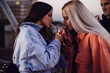 © chika_milan - Two teenage girls lighting up cigarettes and smoking.