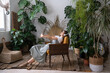 © DimaBerlin - Relaxed calm woman rest in home garden breathing fresh air, listen music. Happy gardener girl enjoy mental balance and wellbeing in greenhouse. Satisfied young lady taking pleasure of stress relief