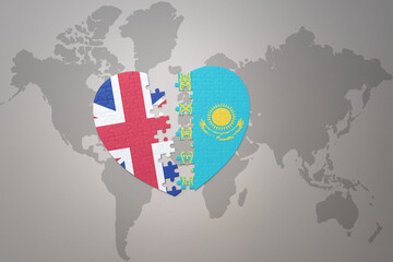 Wall Mural - puzzle heart with the national flag of kazakhstan and great britain on a world map background. Concept.