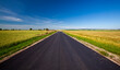 © rsooll - an asphalt road with a blue cloudless sky