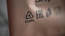 4k Close View Of 4 LDPE Recycling Sign Or Label And Others On Paper Packaging