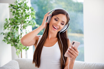 Sticker - Photo of pretty lovely lady listen music using smart gadget headset enjoy in modern apartment comfy interior