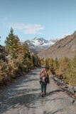 Fototapeta Natura - Woman hiking in the mountains in Zermatt.