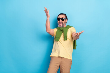 Poster - Photo of overjoyed person raise arms have fun good mood toothy smile isolated on blue color background