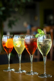 Fototapeta Uliczki - mixed spritzer wine cocktails selection with fruit in outdoor bar