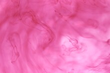 Shallow Depth Of Field Shot Of Swirling Pink And Blue Ink In Water - Soft Flowing Abstract And Soothing Backdrop