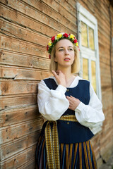 Wall Mural - Woman in traditional clothing posing on nature in village.