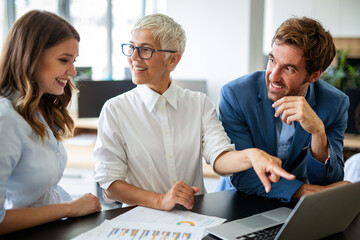 Portrait of successful business people working together in corporate office.