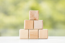 Group Of Wooden Cube Block On Green Summer Background With Copy Space